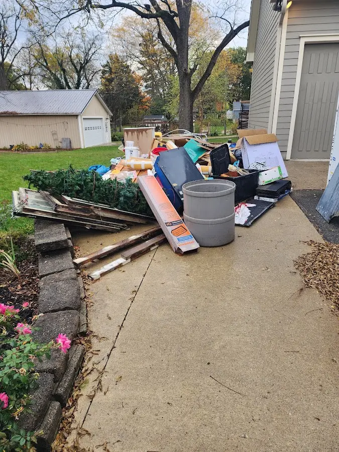 Dumpster being loaded with debris for Estate Cleanout Dumpster Rental in Potsdam
